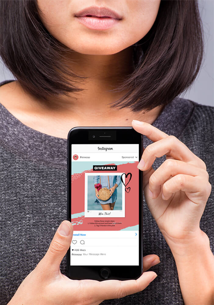 Mockup Of A Space Gray Iphone 8 Held By A Woman Wearing A Gray Sweater 22170 Copy